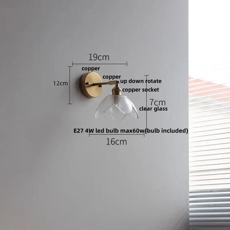 Modern brass flower glass base led wall sconce featuring a delicate copper finish and clear flower-shaped glass shade for bedroom decorbites wall sconce