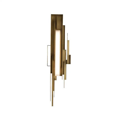 Modern brass wall lamp with geometric layered design featuring vertical bars and an illuminated elegant wall panel