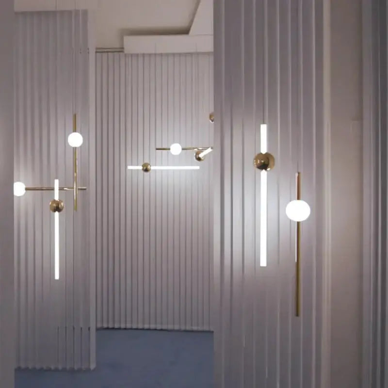 Modern brass glass pendant lights with gold metal frames and frosted glass spheres for dining room ambiance