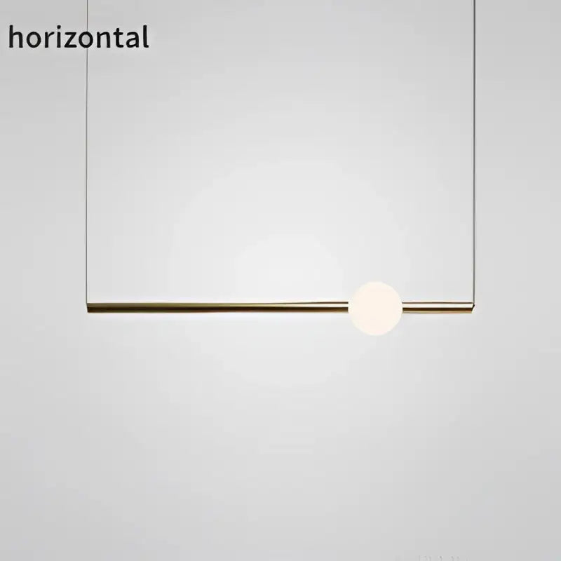 Minimalist modern brass pendant lights with a sleek rod and white glass pendant bulb for dining room use