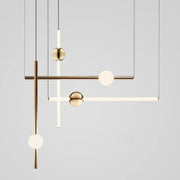 Modern brass geometric glass pendant lights featuring spherical glass orbs and minimalist rods for dining room use