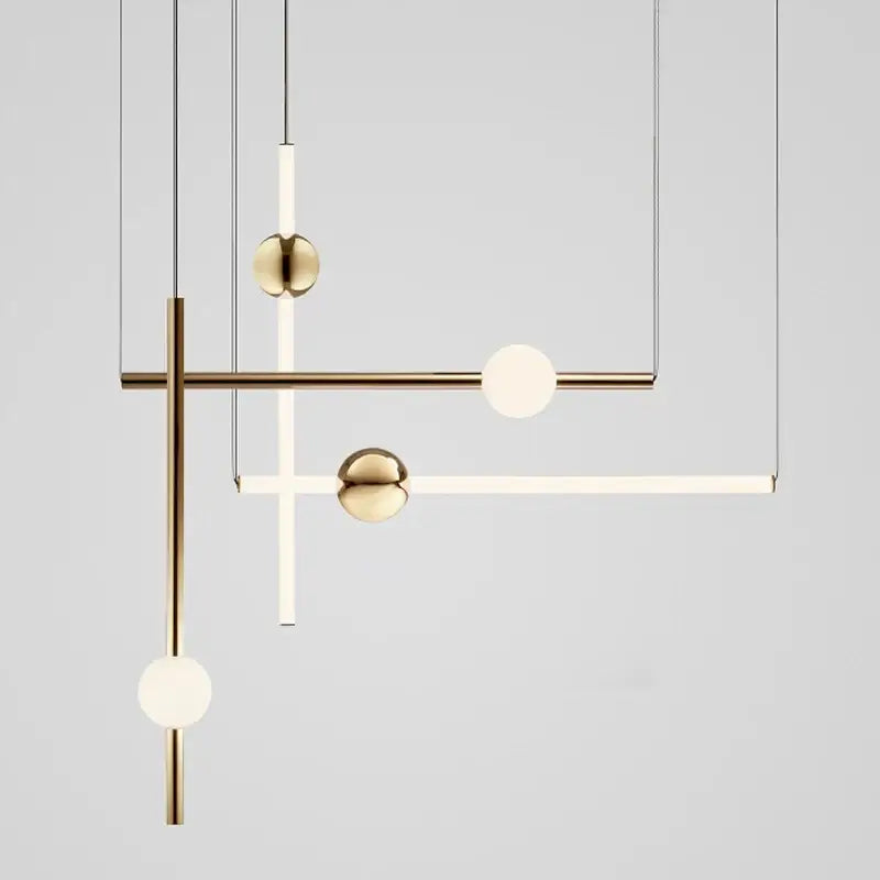 Modern brass geometric glass pendant lights featuring spherical glass orbs and minimalist rods for dining room use