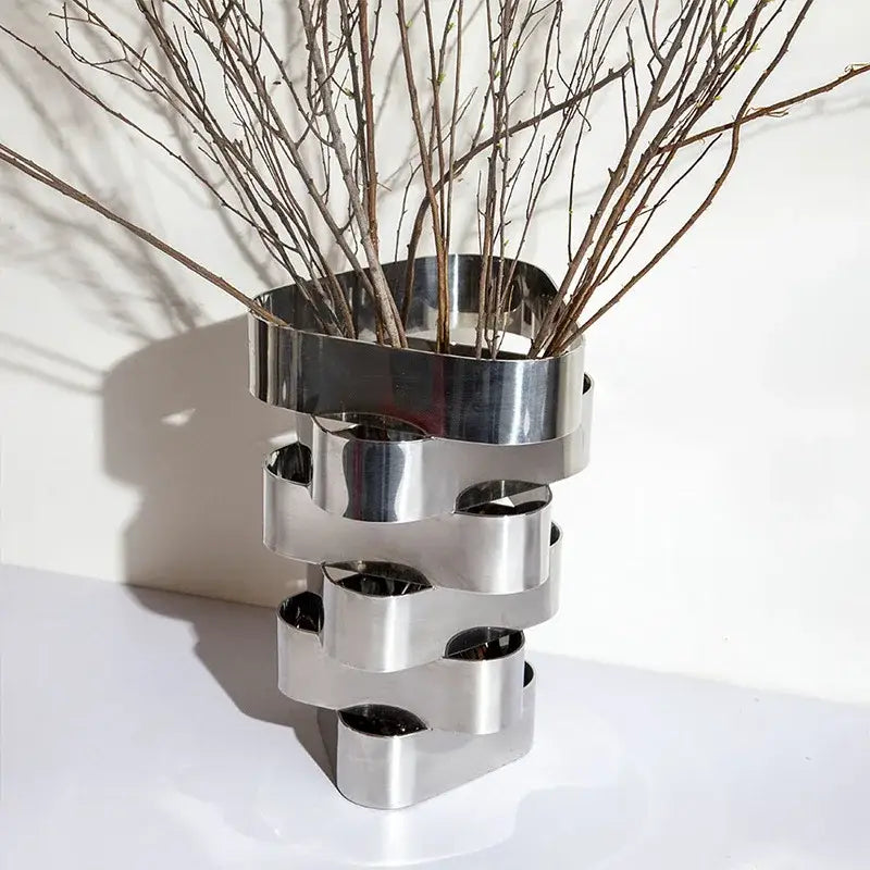 Modern brass geometric vase by decorbites featuring a sleek metallic silver finish and interlocking ring design for living room decor
