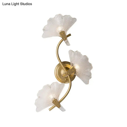 Modern brass ginkgo leaves wall light with gold-toned metal and three translucent fan-shaped glass shades for bedroom use