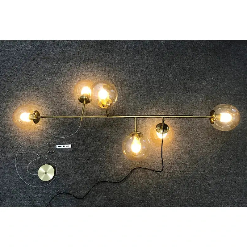Modern brass glass ball chandelier wall sconce with five warm light spherical bulbs for living room decorbites brass glass