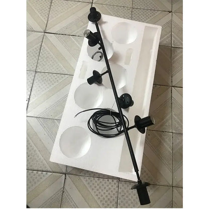 Black metal adjustable spotlight fixture with multiple heads and coiled power cord for modern brass glass ball chandelier decorbites brass glass