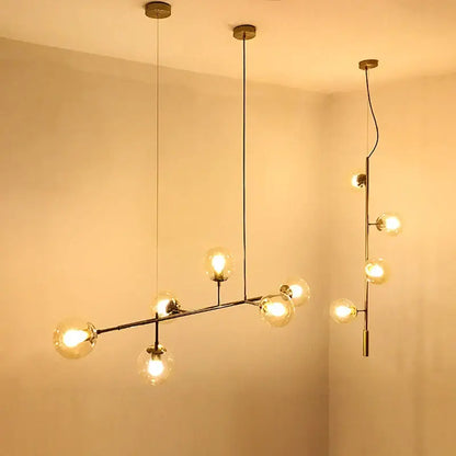 Modern brass glass ball chandelier with multiple spherical bulbs in asymmetrical branch design for living room decor