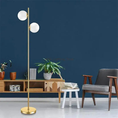 Modern brass glass ball floor lamp with gold finish and two white spherical glass shades for bedroom and study decorbites floor lamp