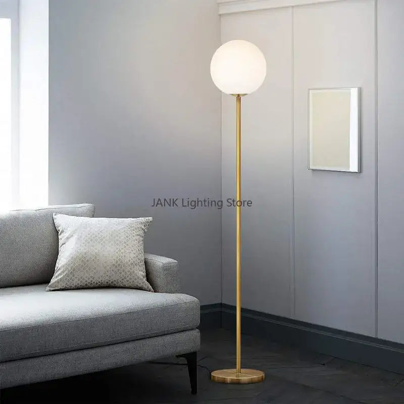 Modern brass glass ball floor lamp with gold finish and white spherical glass shade for bedroom and study decorbites floor lamp