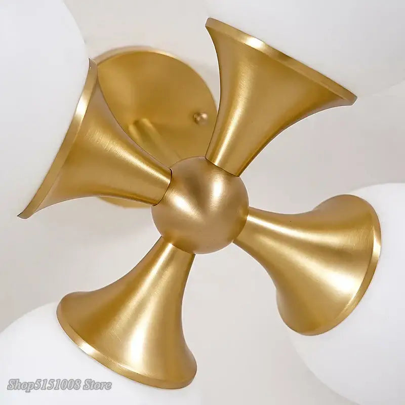 Modern brass glass ball led ceiling lights featuring gold-toned brass fixture with four flared arms for living room decorbites glass ball