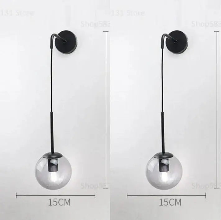 Modern black metal wall light with clear glass globe shade featuring decorbites glass ball led design for bedroom use