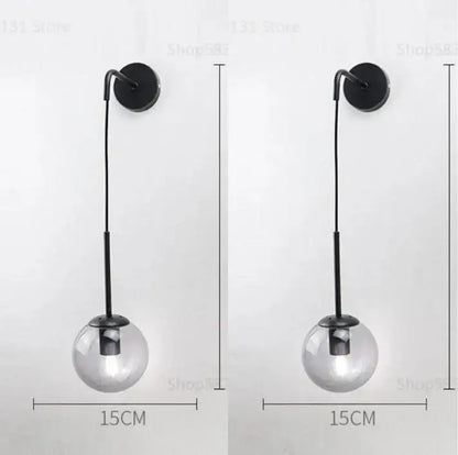 Modern black metal wall light with clear glass globe shade featuring decorbites glass ball led design for bedroom use