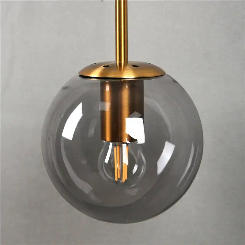 Modern brass glass ball led wall light with translucent gray glass globe and exposed filament bulb for bedroom decorbites glass ball