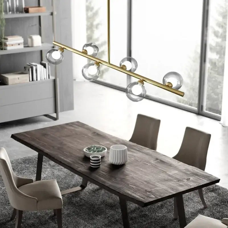 Modern brass glass ball pendant chandelier featuring clear glass globe bulbs ideal for dining room decorbites glass ball