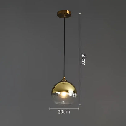 Modern brass glass ball pendant light with gold finish clear glass globe and black cord for dining and kitchen decorbites
