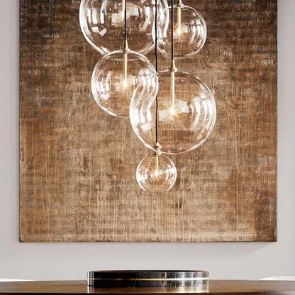 Modern brass glass ball pendant light featuring a clear glass globe with brass accents for kitchen decorbites decorbites glass ball pendant