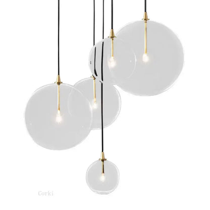Modern brass glass ball pendant light with gold-toned metal accents and black cords for kitchen decorbites glass ball lighting