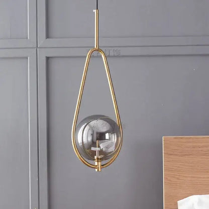 Modern brass glass ball pendant lighting featuring a gold-toned teardrop glass ball pendant for bedroom decorbites glass ball