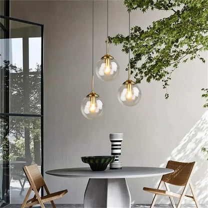 Three modern brass glass ball pendant lights with glass globe shades for dining room decorbites glass ball pendant set