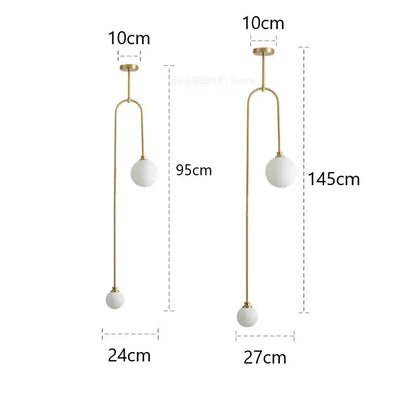Modern brass decorbites glass ball pendant lights with gold-toned arms and two white frosted glass ball globes for dining room decor