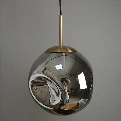 Modern brass glass ball pendant lights set of 2 with sleek spherical chrome finish and brass-toned hanging rod for kitchen decorbites