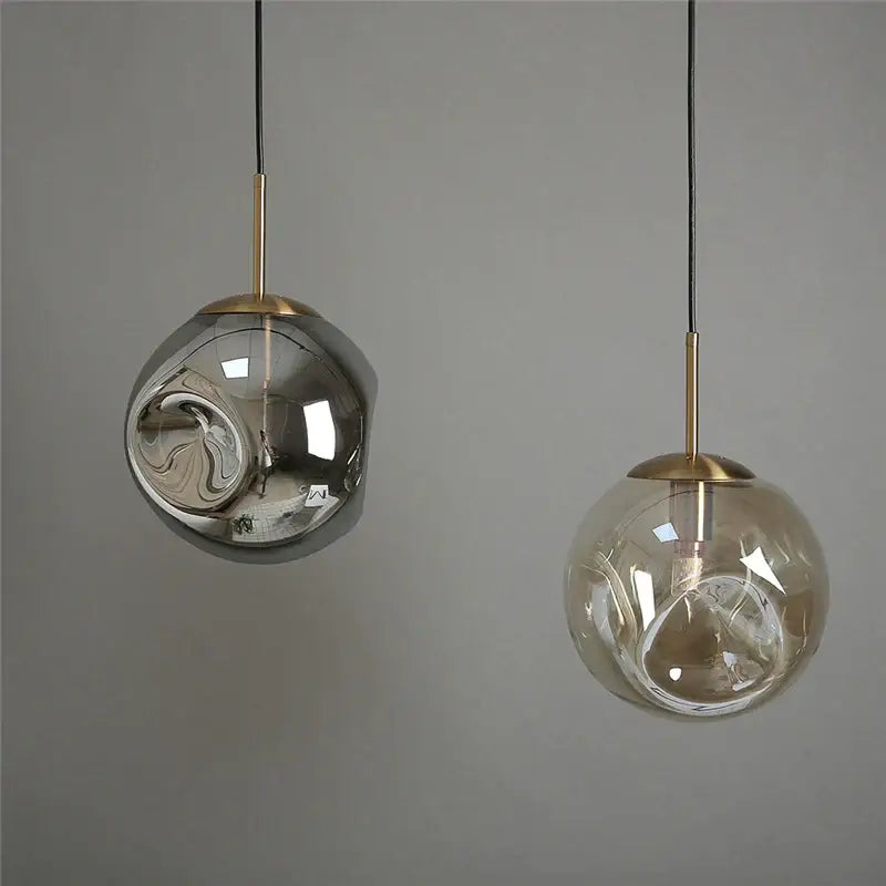 Two modern brass glass ball pendant lights with silver reflective and amber translucent globes for kitchen decorbites glass ball set