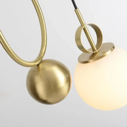 Modern brass glass ball pulley pendant light with brass finish, opaque frosted glass globe, and polished metallic sphere