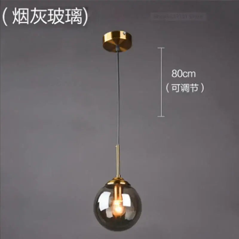 Modern brass glass ball wall lamps featuring a smoky glass globe and polished brass hardware for bedroom decorbites glass ball