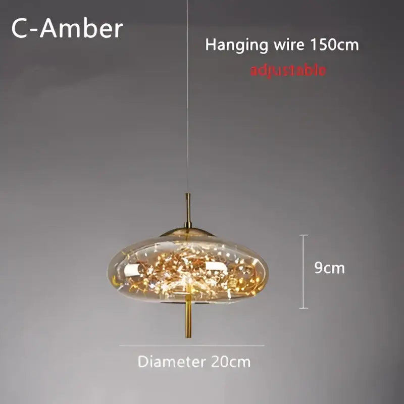 Modern brass glass cord pendant light with gold-toned metal frame and clear glass shade filled with golden crystals