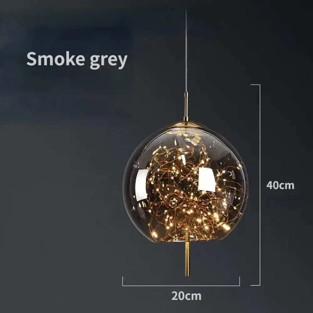 Modern brass glass pendant light featuring a smoke grey glass pendant with golden filament led chandelier accents