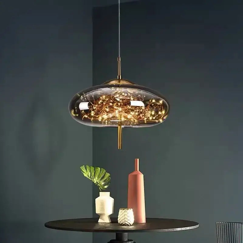 Modern brass glass pendant light featuring a translucent dome and warm glowing string lights for bedroom use