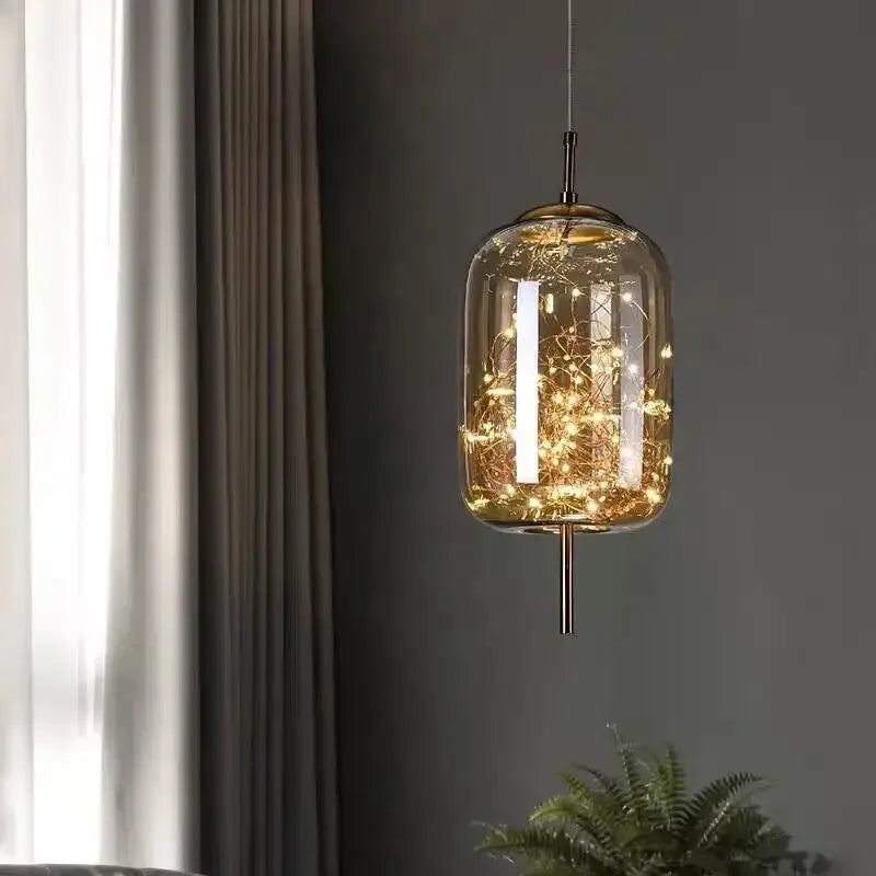 Modern brass glass pendant light featuring warm-toned glass pendant with intricate fairy lights for bedroom use