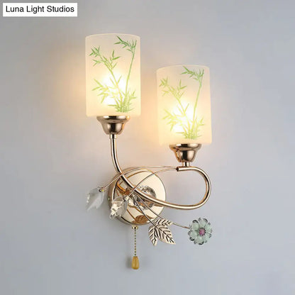 Modern brass wall lamp with glass shade, pull chain, frosted glass featuring green bamboo and crystal leaf accents