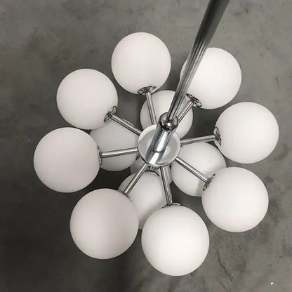 Modern chrome-finished globe pendant lamp with multiple frosted white glass globes for stylish dining room lighting