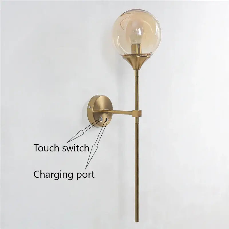 Modern brass wall lamps featuring a golden glass ball amber bulb and elongated stem for bedroom decorbites golden glass