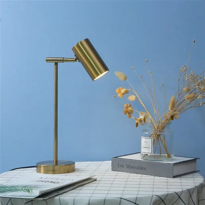 Brass-finished adjustable table lamp with cylindrical head and slender stem ideal for study and reading decorbites golden table lamp