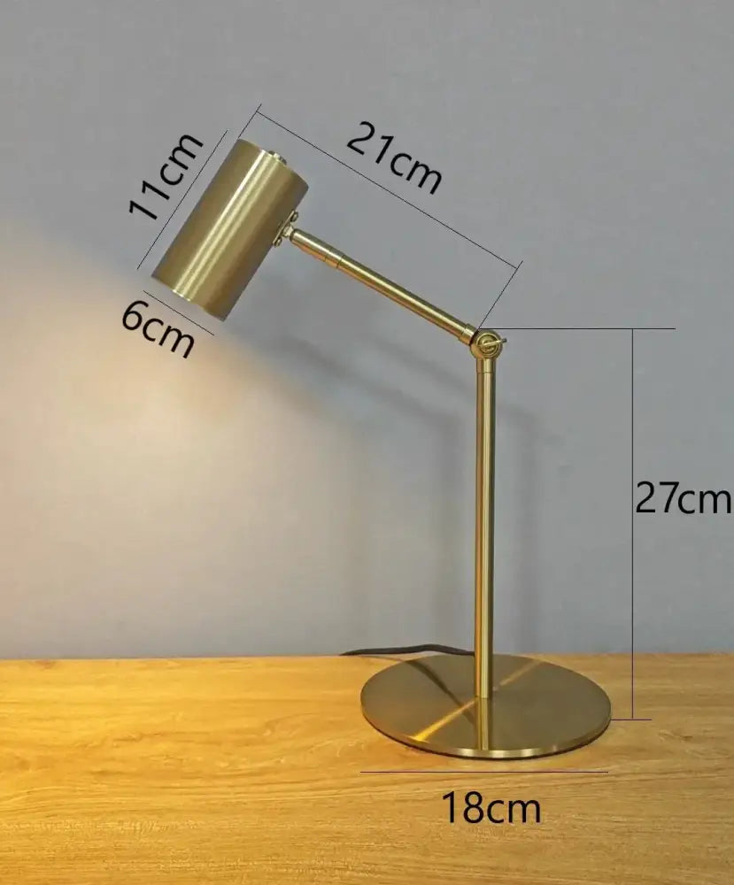 Modern brass golden table lamp with adjustable cylindrical head and circular base perfect for study and reading decorbites golden table lamp