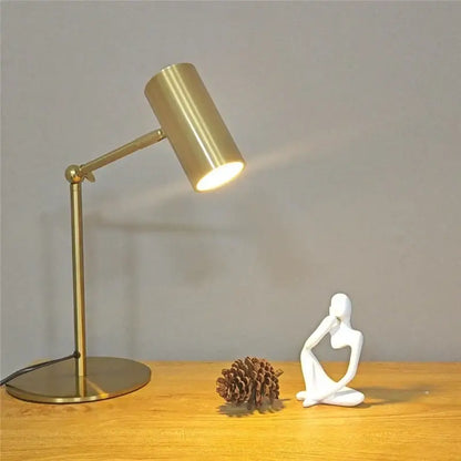 Modern brass golden table lamp with adjustable cylindrical head and circular base perfect as a decorbites golden table lamp