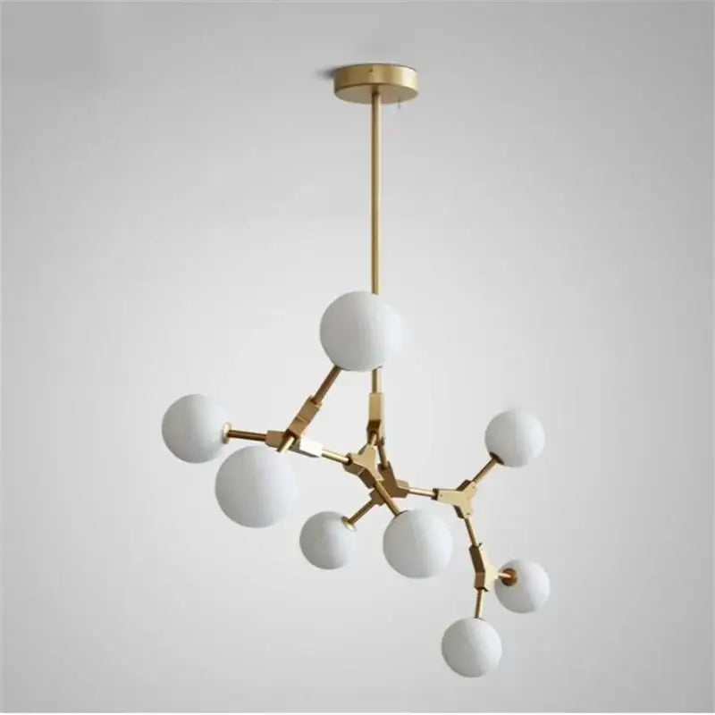 Modern brass iron magic pendant lights featuring gold-toned iron and white glass globes in molecular design decorbites iron magic