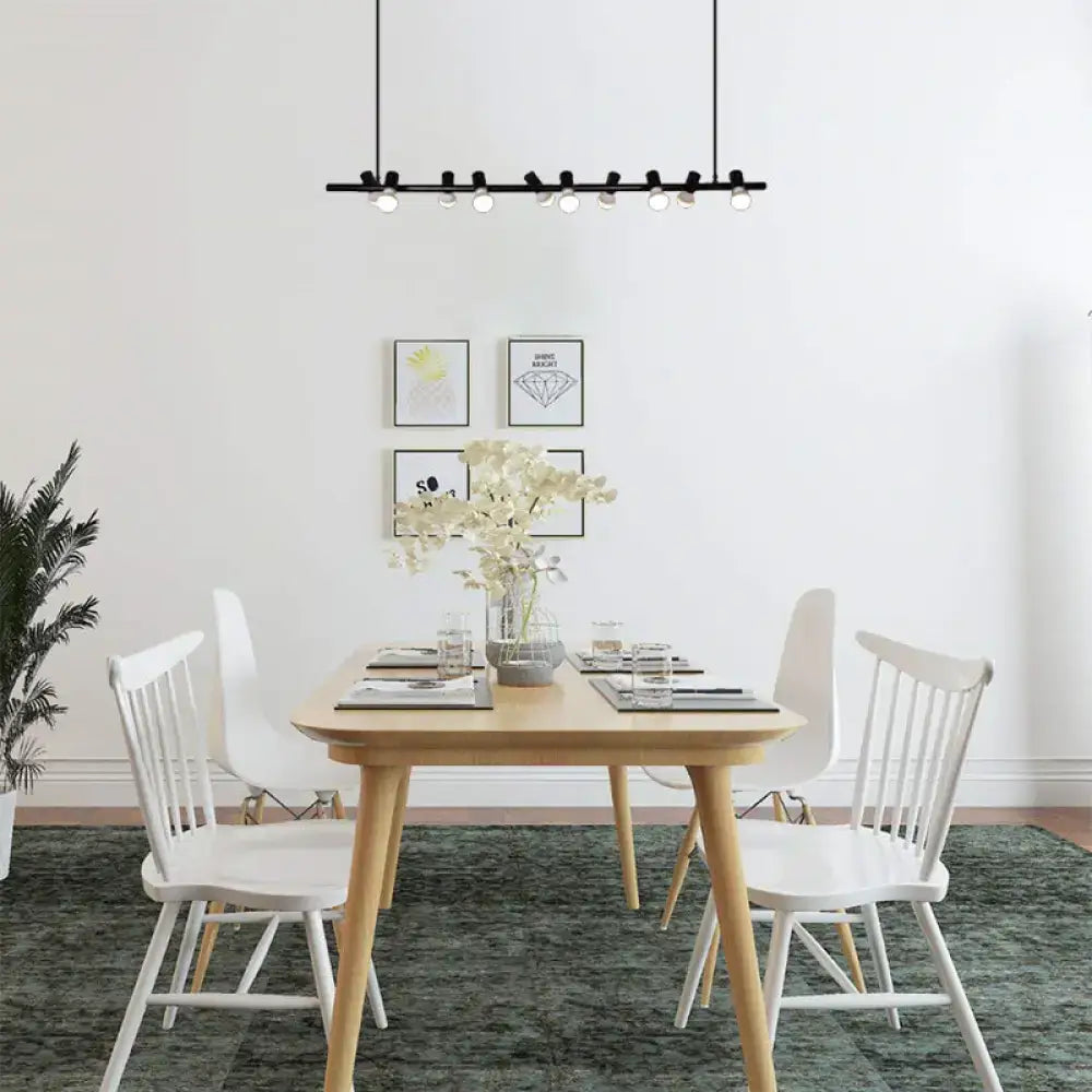 Light wood dining table with four white chairs and black metal island lamp hanging light with maximum bulb wattage design