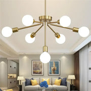 Modern brass nordic ceiling chandelier with six white glass bulbs and one central bulb in minimalist geometric design