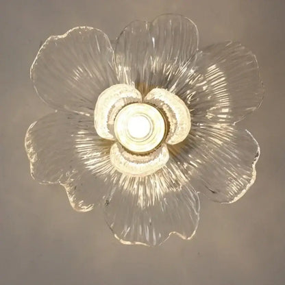 Modern brass orchid clear glass led ceiling lamp with textured flower-shaped petals and central illuminated bulb for bedroom