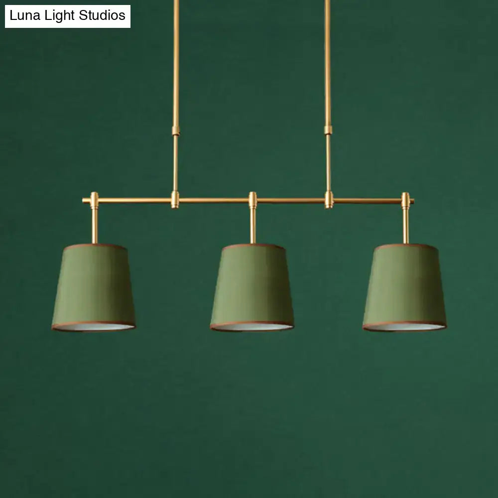 Modern brass pendant light with three olive green fabric shades featuring white green flaxen texture for dining room use