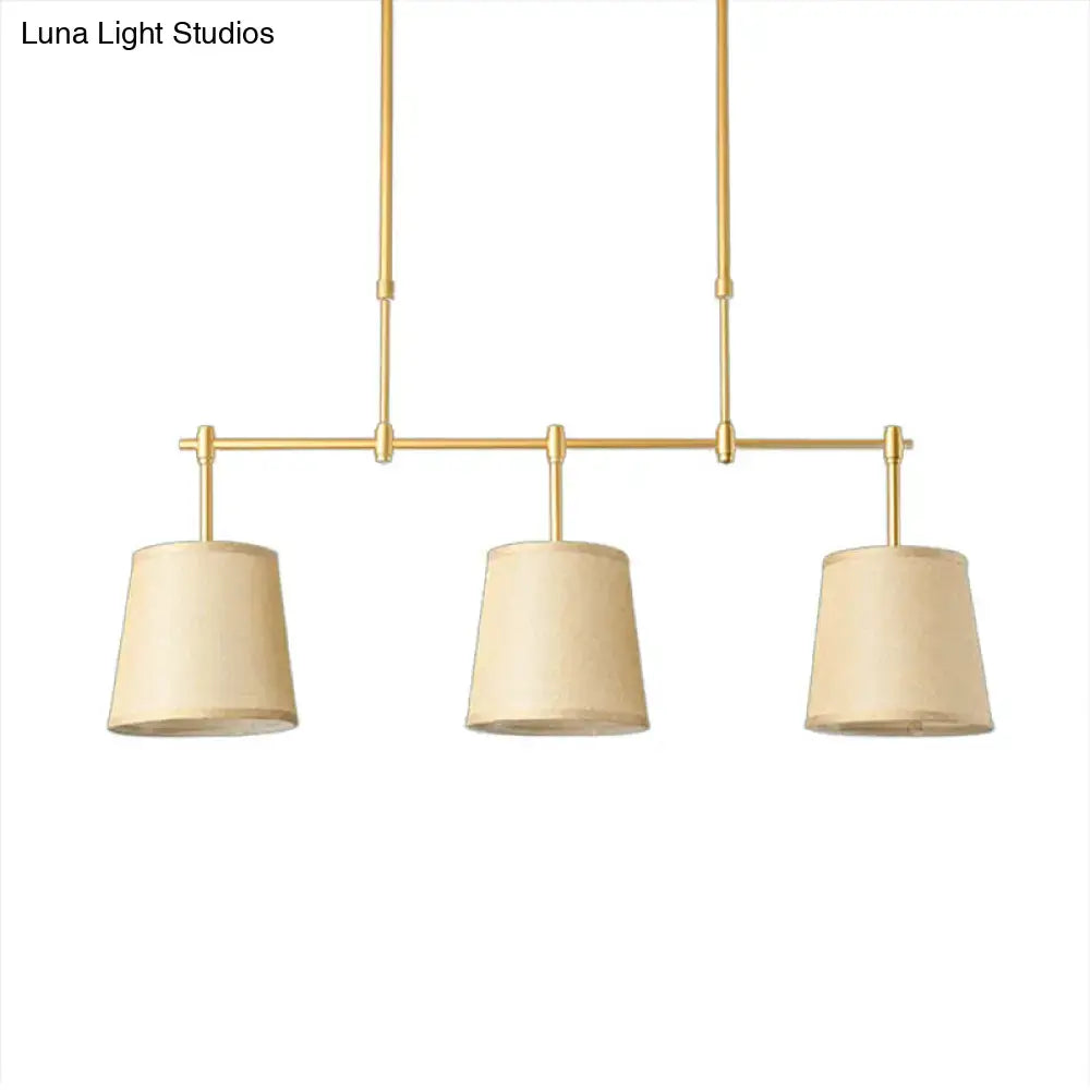 Modern brass pendant light with three beige fabric white green flaxen shades for dining room lighting