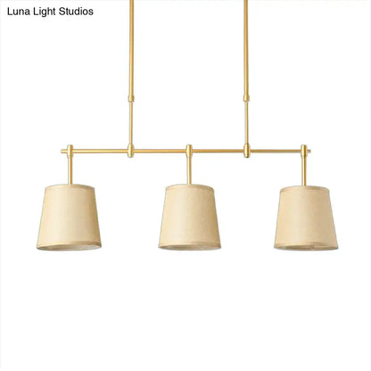 Modern brass pendant light with three beige fabric white green flaxen shades for dining room lighting