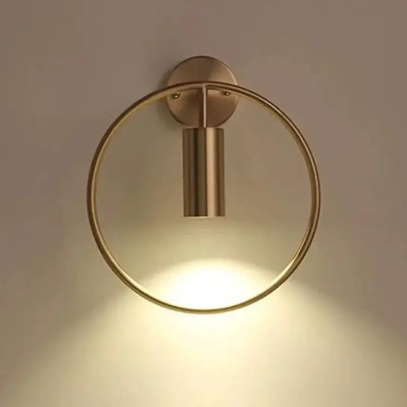 Modern brass ring led wall lamp with circular ring and cylindrical light fixture for bedroom sconce lighting