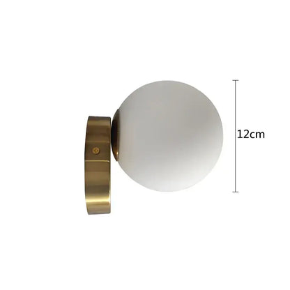 A sleek modern brass round ceiling lamp with a frosted white glass round globe for hallway lighting
