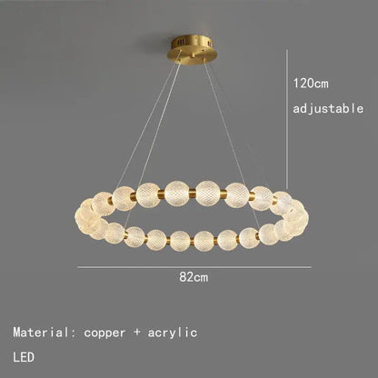 Modern brass round led pendant lights feature a gold-toned double-ring chandelier with textured acrylic spheres and copper accents