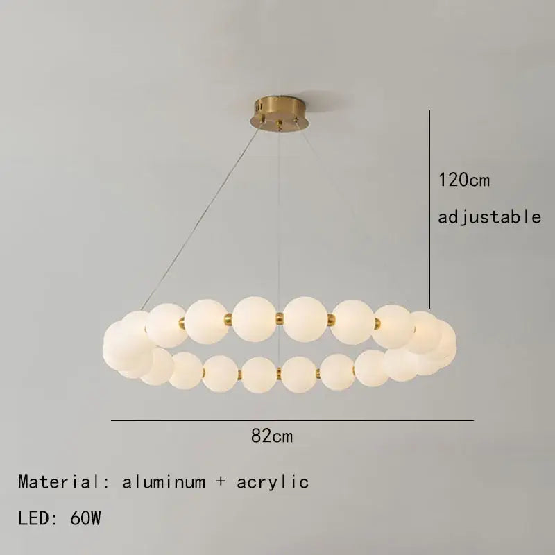 Modern brass round led pendant lights featuring frosted white acrylic spheres and decorbites brass round fittings