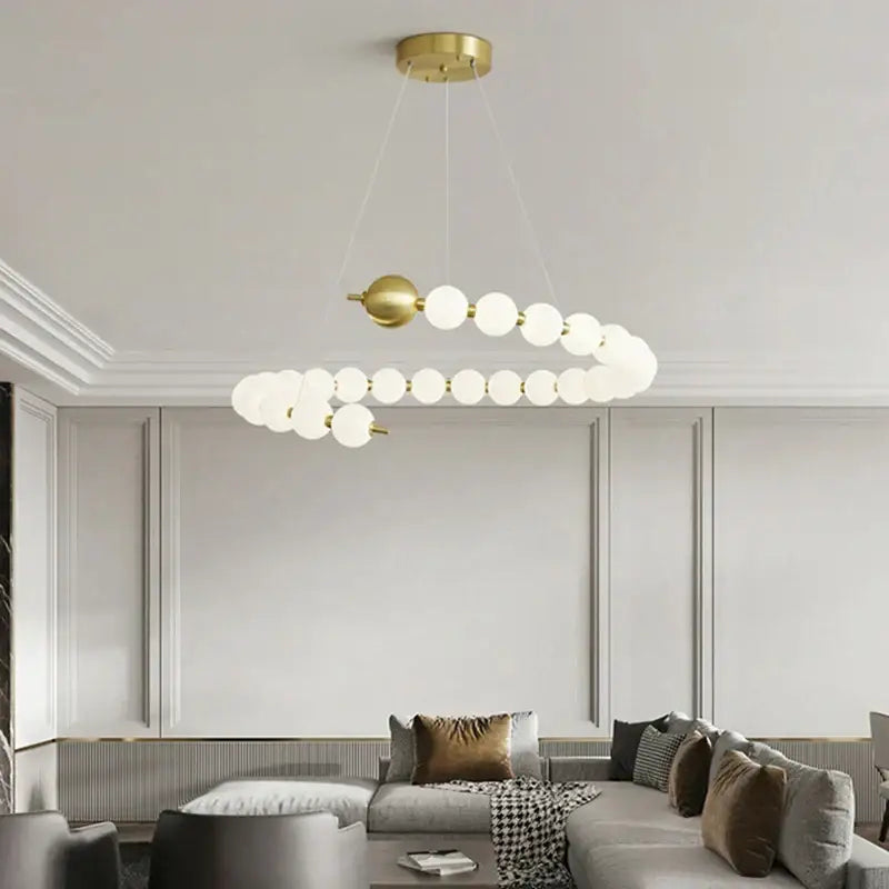 Modern brass round led pendant lights featuring a gold-toned spiral chandelier with frosted glass globe bulbs for dining room decorbites brass round